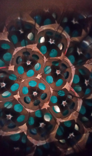 A close-up shot showcasing the intricate, symmetrical patterns and vibrant circular designs of the kaleidoscope.