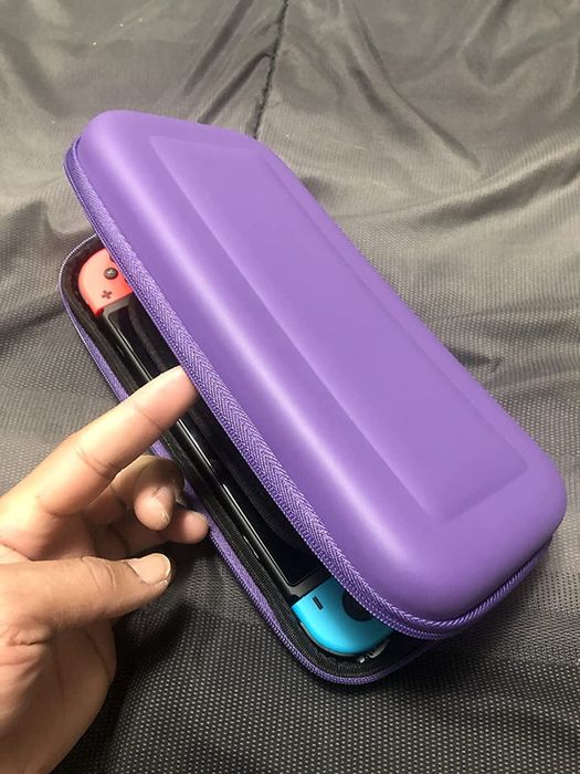 a reviewer's Switch inside a purple carrying case