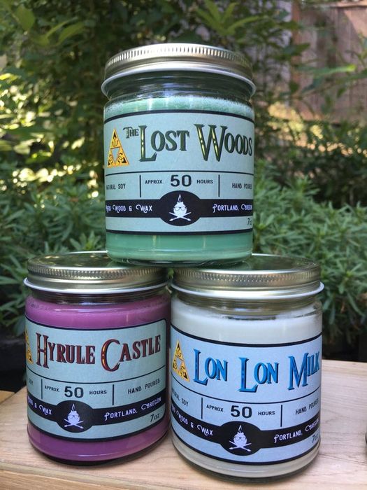 A green Lost Woods candle, a purple Hyrule Castle candle, and a white Lon Lon Milk candle.