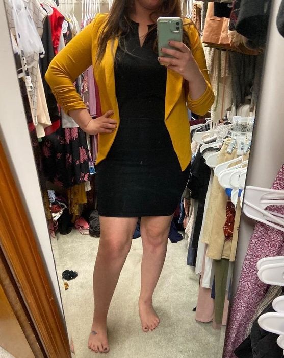 An Amazon customer is seen wearing a yellow blazer-style cardigan.