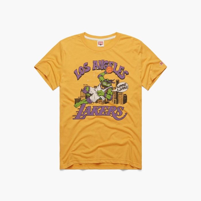 A vibrant yellow tee featuring a Teenage Mutant Ninja Turtle in mid-basketball dunk with the phrase