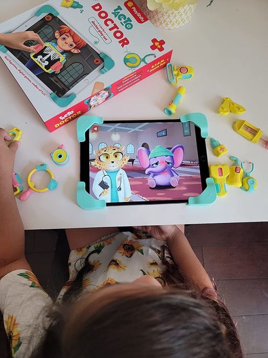 a reviewer photo of a child playing doctor with the Tacto set on their tablet