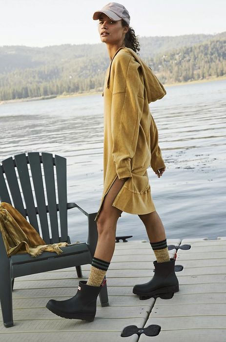Model wearing a yellow hoodie dress