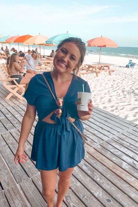 front view of another reviewer wearing the blue version of the jumpsuit