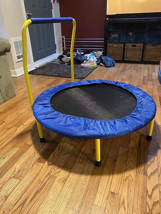 Reviewer's image of the blue trampoline set up in a living room