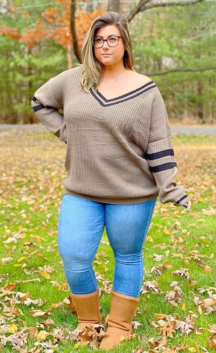 Another reviewer is seen outside wearing the khaki sweater, paired with blue jeans and brown boots.
