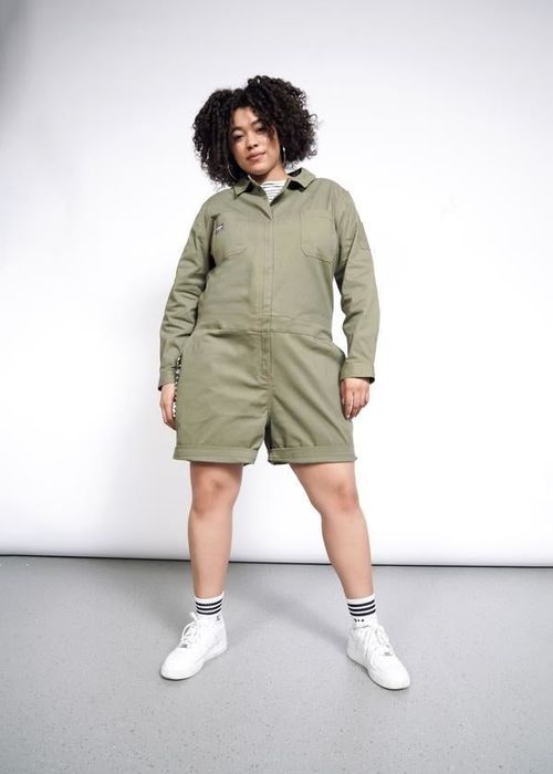 another model showcasing the army green version of the romper