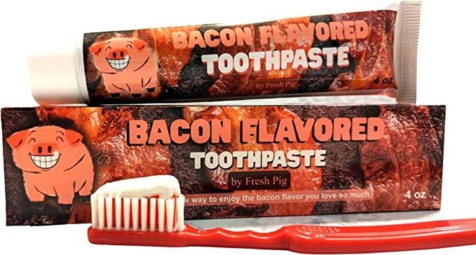 The toothpaste tube and a toothbrush with some on it