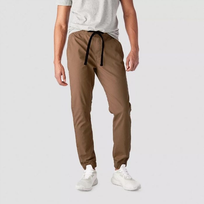 A model sports brown joggers featuring a black drawstring.