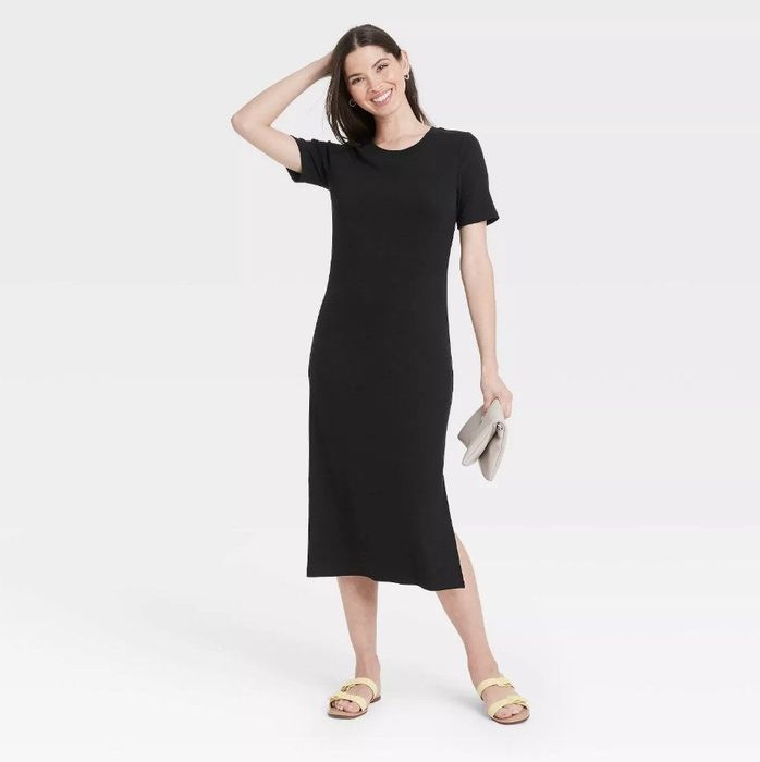 Model wearing a short-sleeve, long black T-shirt dress