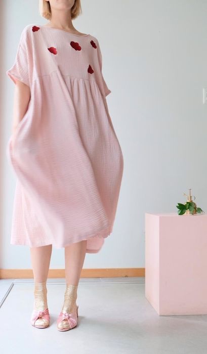 a different model wearing the pink version of the dress