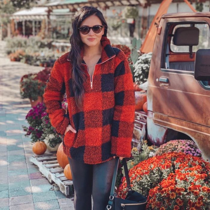 The reviewer is wearing an orange-red Zesica quarter-zip pullover.