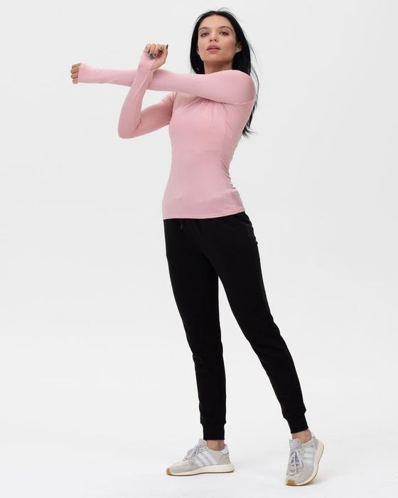 a model wearing the shirt in light pink