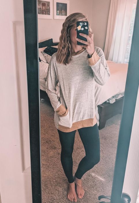 An Amazon reviewer is wearing a khaki tunic-style sweater.