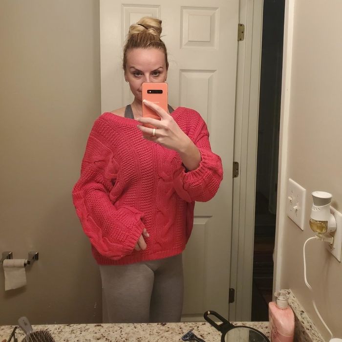 The reviewer is wearing the Astylish cable-knit sweater in a soft rose hue.