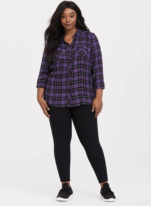 A model is wearing black Torrid fleece-lined leggings.