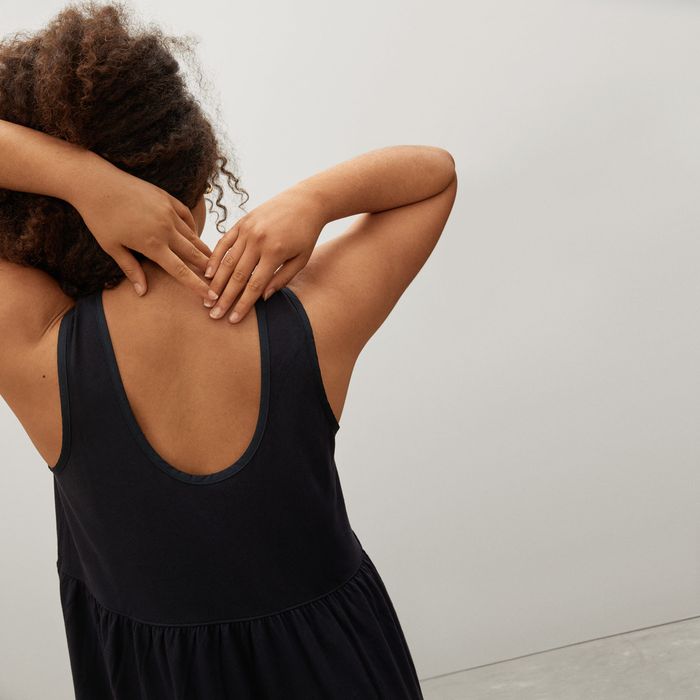 back view of another model wearing the black version of the dress