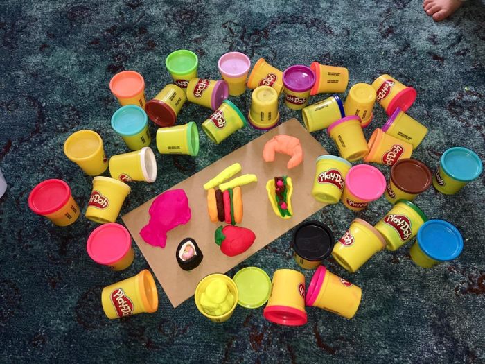 A reviewer's image showing the 36 Play-Doh cans along with several food items shaped out of Play-Doh