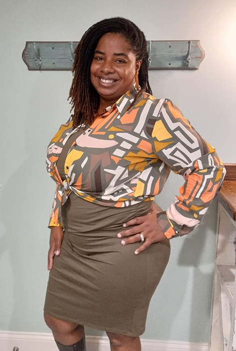 a reviewer wearing the same blouse with a more subtle multicolor print