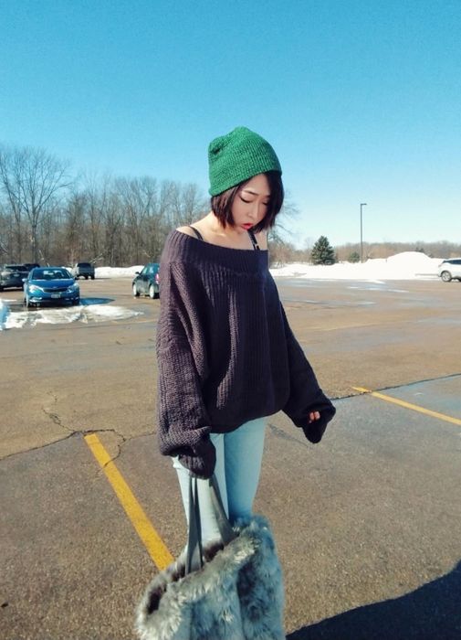 The same reviewer is sporting the same sweater, but this time in black.