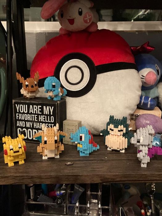 a collection of various Pokémon Nanoblocks displayed on a shelf