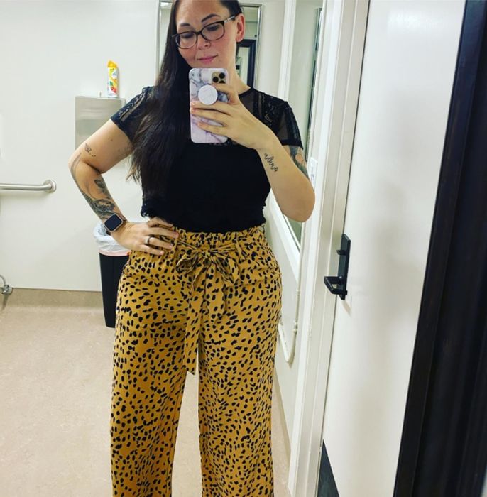 A reviewer wearing the khaki and navy dot-print pants