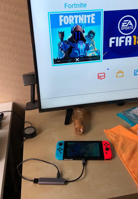 a reviewer's setup with their Switch connected to a TV via the portable dock