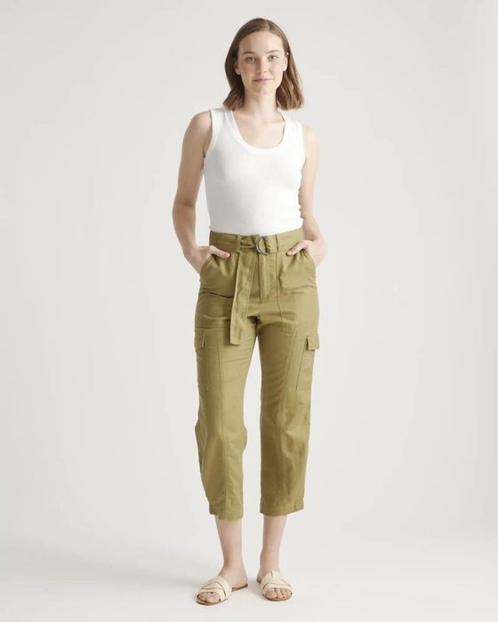 A white top paired with green pants and white shoes