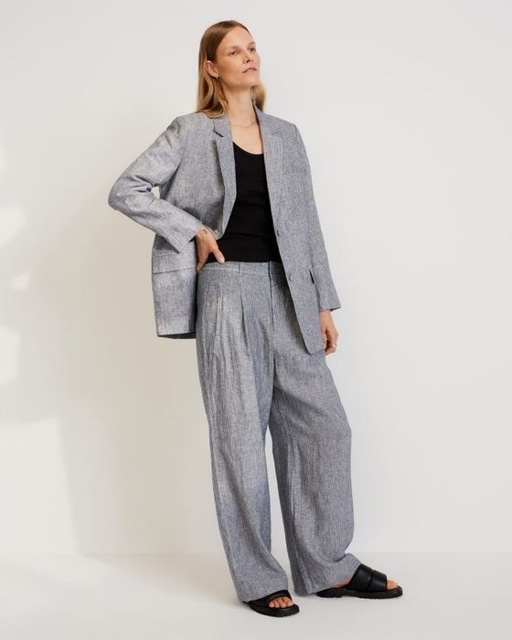 another model wearing navy pants paired with a matching blazer