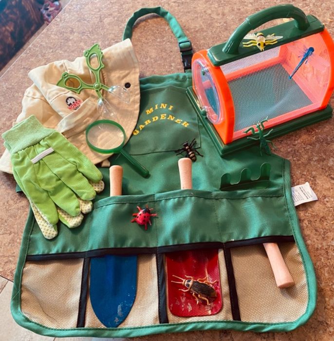 Reviewer image showcasing the full kid's gardening set resting on top of an apron