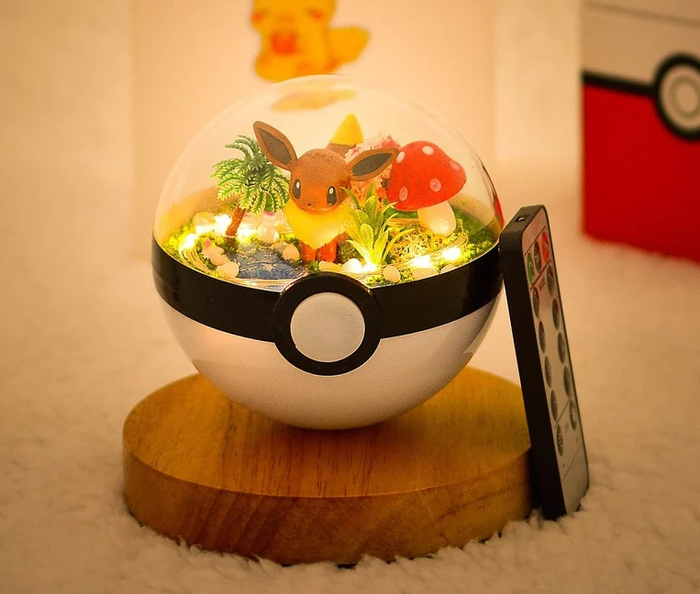 an Eevee in a Poké Ball terrarium