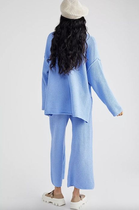 Model wearing a blue sweater set