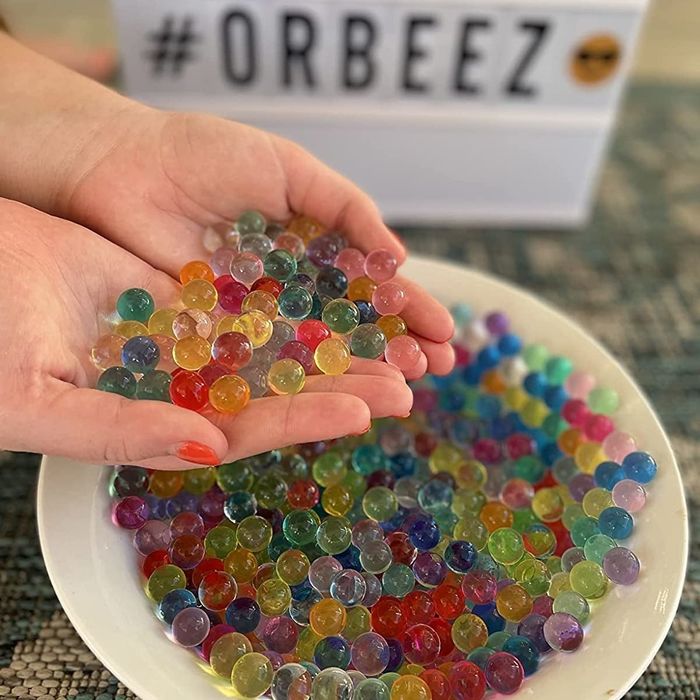 A reviewer showing off the expanded water beads in their hand, ready to be used in play