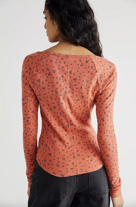 Model wearing a pink printed top