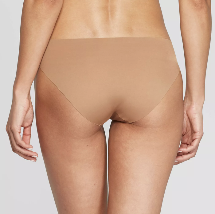 A model styled in no-show underwear in a soft tan color.