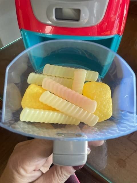 The toy tray open, displaying the color-changing toy food