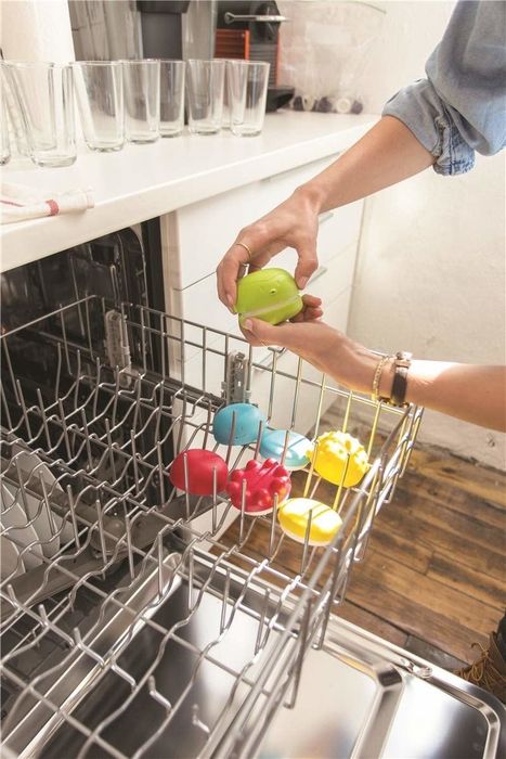 person putting the toys in the dishwasher