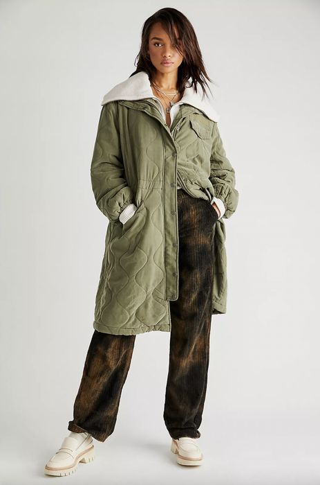 Model wearing a green long padded parka