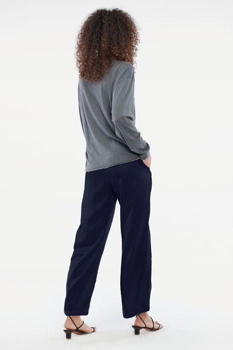 Back view of a model wearing the ink-colored elastic-waist pants