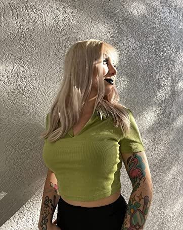 a model showcasing the shirt in light green