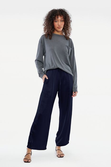 Front view of a model wearing the ink-colored elastic-waist pants