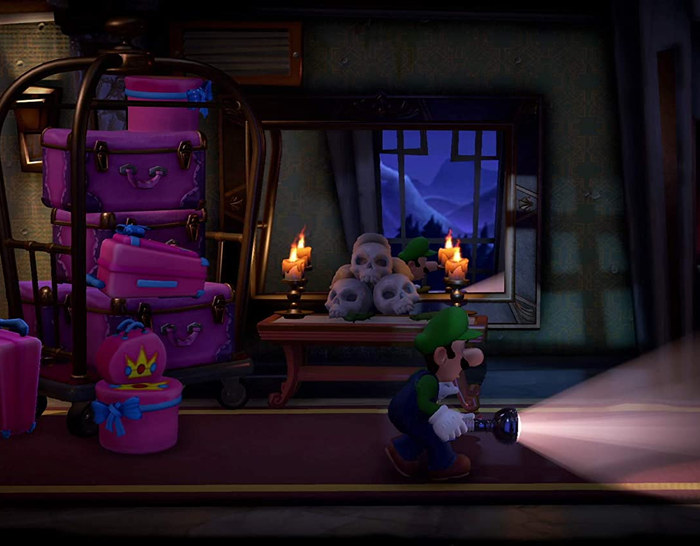 screenshot of Luigi walking cautiously down a dark corridor in Luigi's Mansion 3