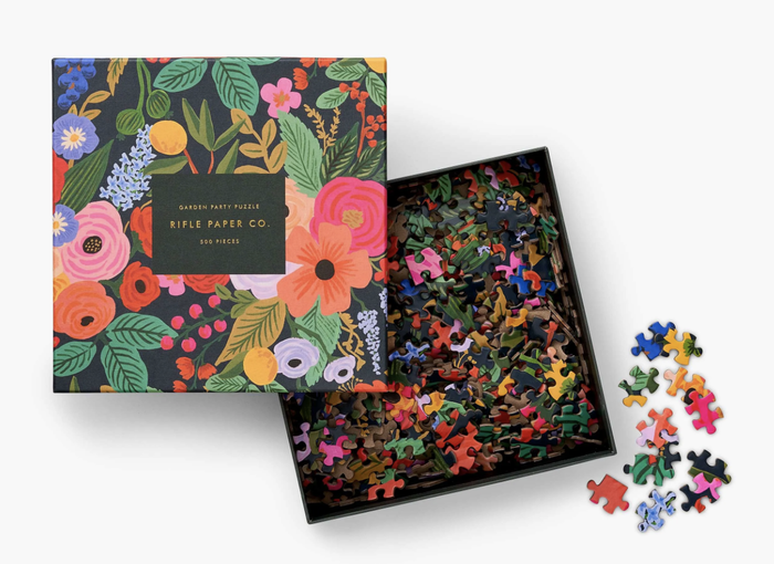A floral 'garden party' puzzle still in its box, waiting to be assembled.