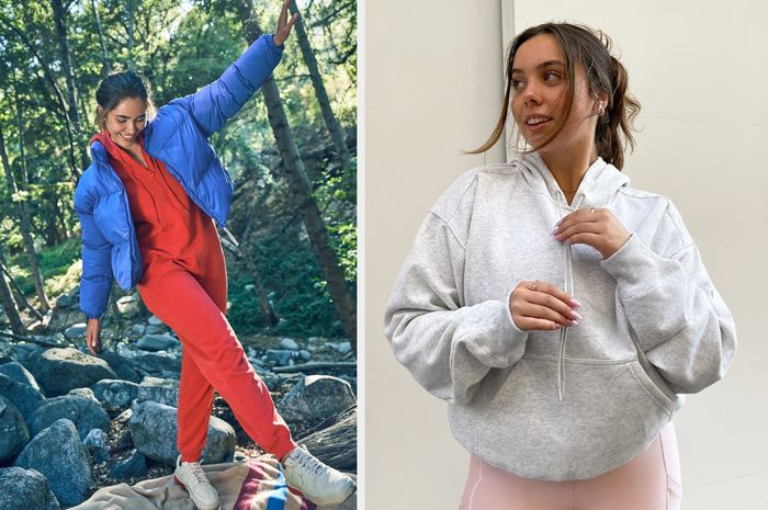 A model walks across rocks outside in a red drawstring onesie with a blue puffer jacket, while another model wears a gray drawstring hoodie paired with pink bottoms in front of a cream-colored wall.