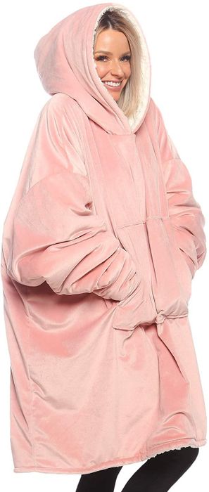 A model wearing a pink blanket sweatshirt.