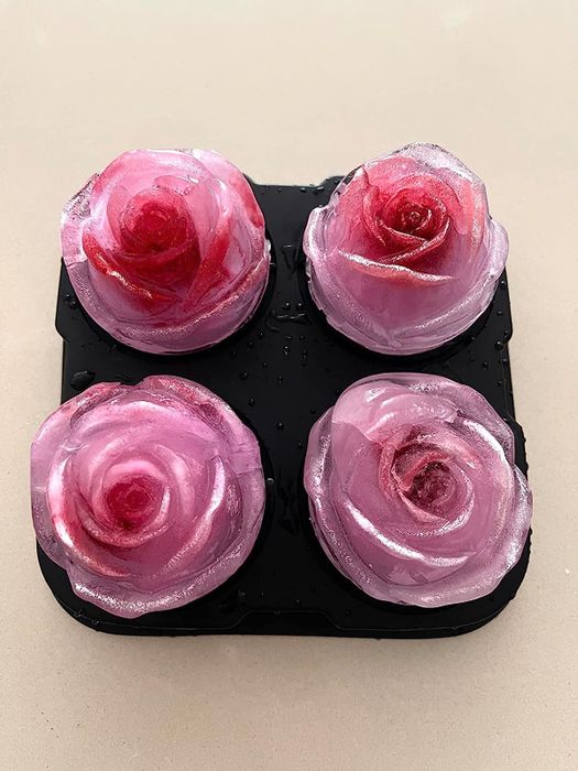 four ice cubes shaped like pink roses