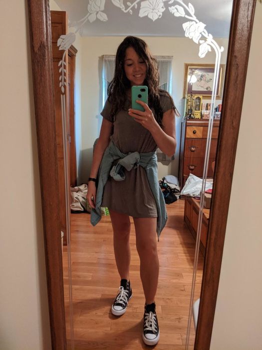 Reviewer styling black Converse sneakers with a gray T-shirt dress