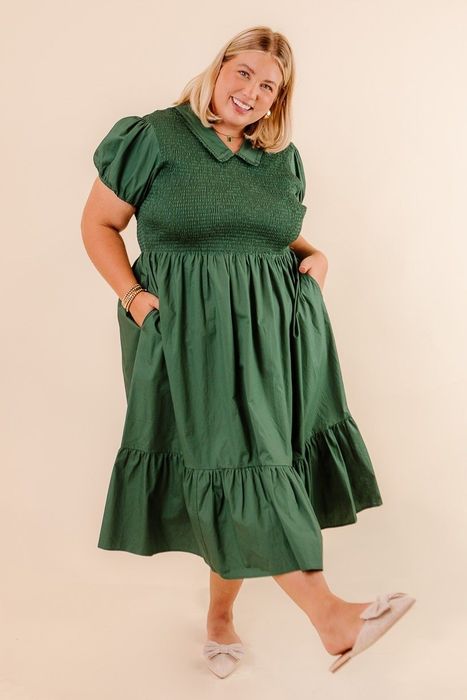 A mid-length green dress with puff sleeves and a playful collar.