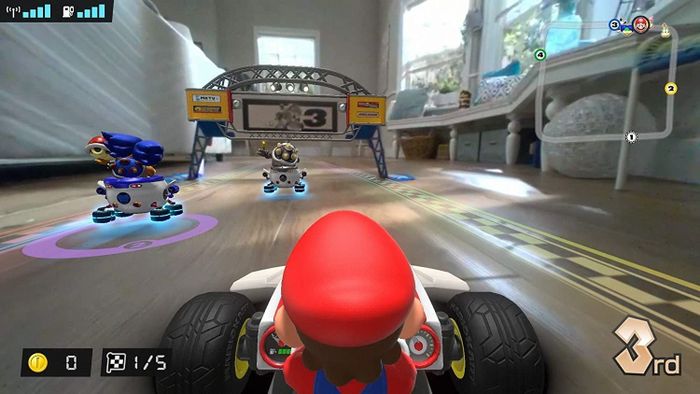 The Nintendo Switch display shows the Mario Kart zooming through the player's home