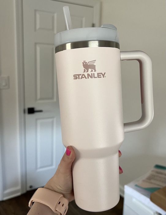 A rose quartz Stanley tumbler.